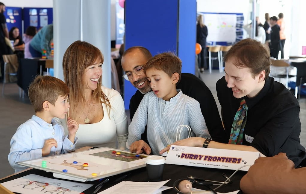 volunteer with families at the vet school stand