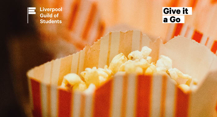 A bag of popcorn, with more bags of popcorn in the background