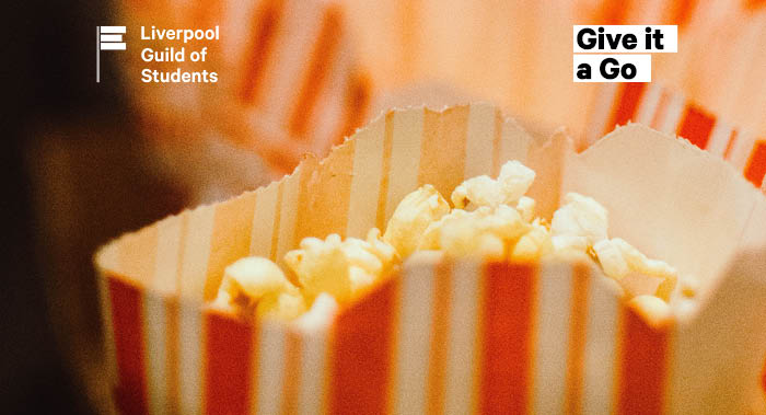 Close up of popcorn in a red and white paper bag