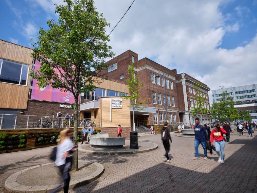 Image of students walking outside the entrance to the Mountford Hall via Guild Walk